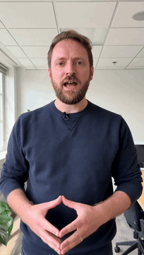 AI generated video: professional presenter in a modern white-walled office setting, framed in a…