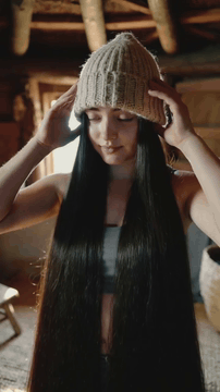 AI generated video: A humble tomboy woman with no make-up in sports top with beanie hiding up all…