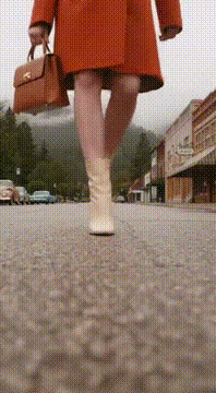 AI generated video: 1960s fashion commercial aesthetic, overcast quiet mountain town. A youthful…