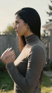 AI generated video: A mysterious modest woman in long-sleeved turtleneck t-shirt with all of her…
