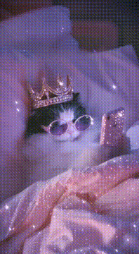 AI generated video: “Crown on. Phone charged. Sleep? Never heard of her 💁‍♀️✨”