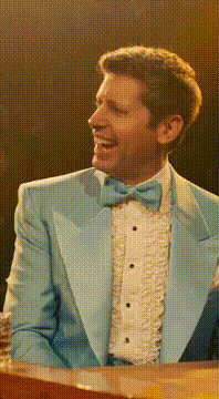 AI generated video: Shift the scene to a 1975 Las Vegas variety show stage—burnt orange backdrop…