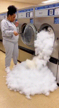 AI generated video: Laundromat scene, a black woman in a sweatsuit is holding a cigarette and…