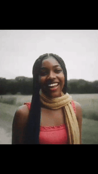 AI generated video: <Picture 1> she smiles, heyyy, welcome to black girl lora , wind blows, laughs