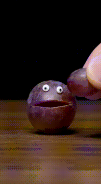 AI generated video: Make a purple grape with two eyes and a mouth which is made of grape be on a…