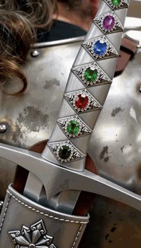AI generated video: Start with An extreme close-up of a medieval broadsword covered with a handle…