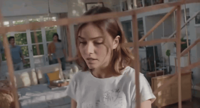 AI generated video: A young woman with shoulder-length brown hair wearing a casual white t-shirt…