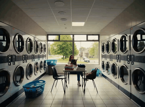 AI generated video: A bright modern laundromat in the middle of the afternoon. Large windows let in…
