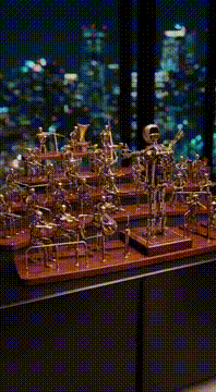 AI generated video: TINY MECHANICAL ORCHESTRA A hyper-detailed, miniature mechanical orchestra…