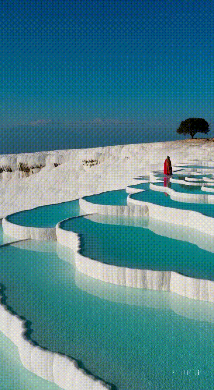 AI generated video: A stunning landscape travel film of Pamukkale's natural travertine terraces in…