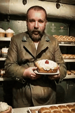 AI generated video: He raises the plate in his hands a little With a russian accent he says: "Как…