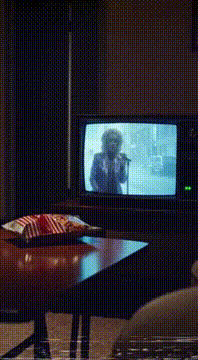 AI generated video: Replace man on TV with @caffed.glamoracle singing tune