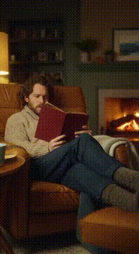AI generated video: A man reads a book in a cozy living room. Suddenly the book floats away…