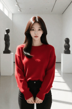 AI generated video: A woman wearing a red sweater stands in the art museum, her hair sways slightly…