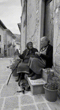 AI generated video: Scene two old ladies speak the Molisano dialect. Lady with cane speaks: cumma’…